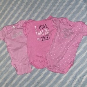 Three pink short sleeved bodysuits
